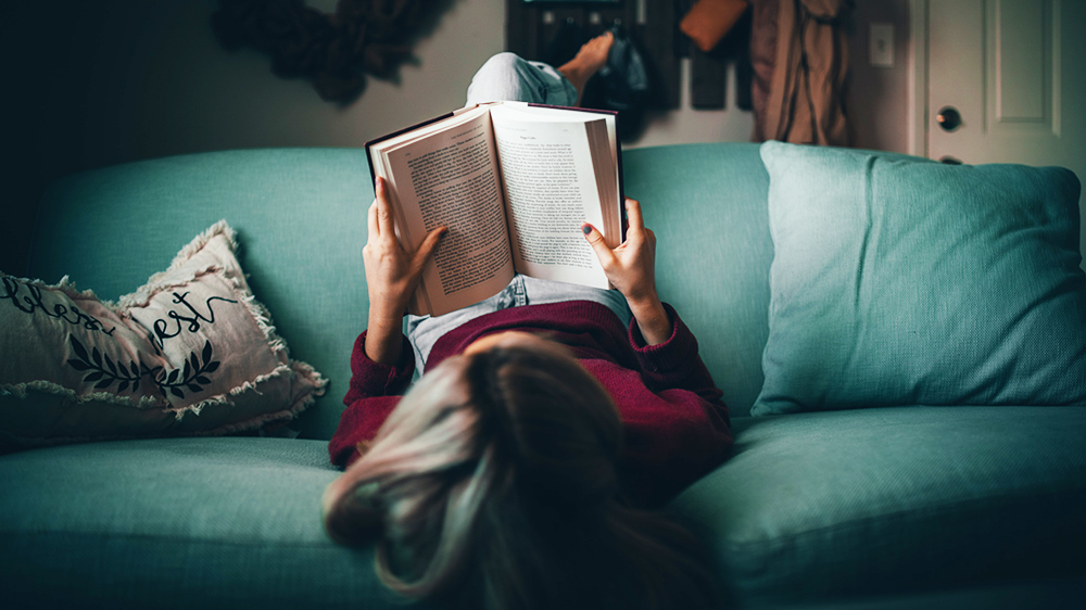 Woman reading on a couch.