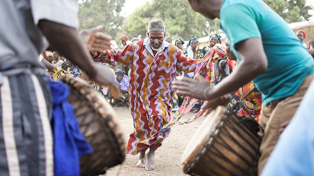 People are dancing to djembe music in Mali.