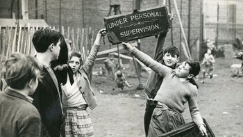 Children holding up a sign that reads quote "under personal supervision"