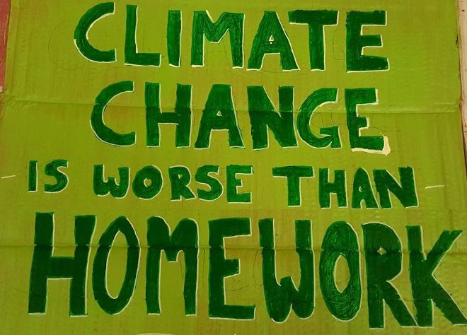Poster saying "Climate change is worse than homework"