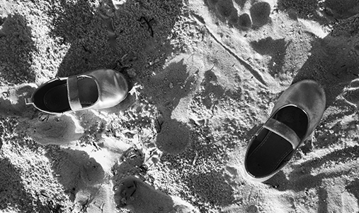 children's shoes in the sand