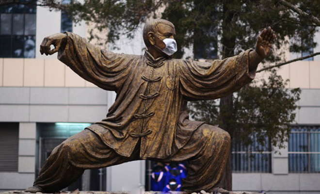 Beijing University statue of a taijiquan practitioner wearing a face mask