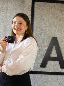 Portrait photo, woman, smile, holding mug, white shirt