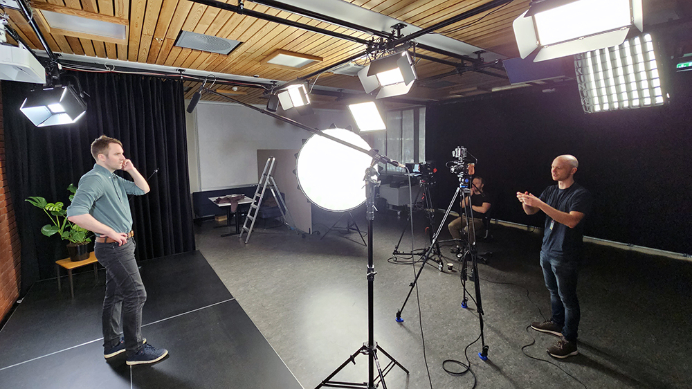 Two of our employees working in the studio. Lighting and camera. Photo.