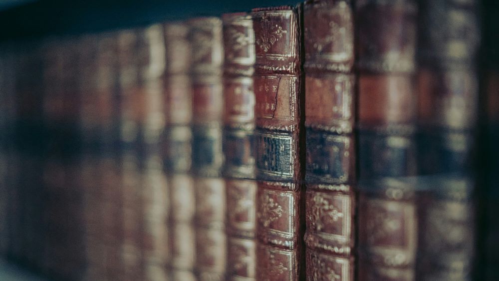 Old leather bound books in a row. Photo.
