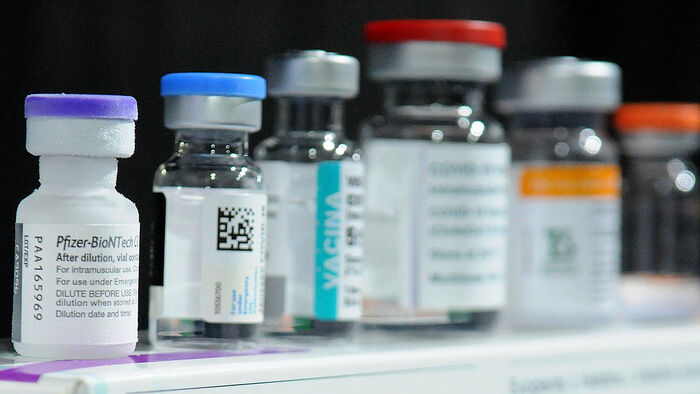 A row of Covid-19 vaccines in small jars