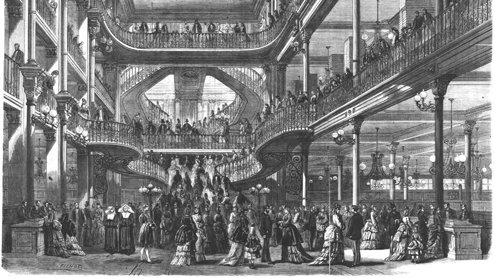 A department store over several floors, with a large staircase, gallery, nice interior and many nicely dressed people. Lithograph.