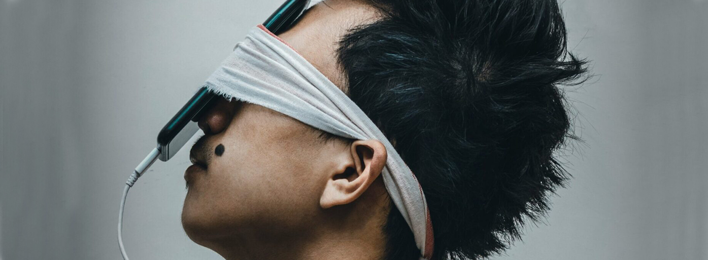 A person looking at a mobile phone. Photo.