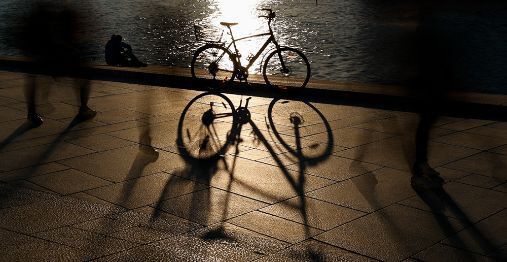 A bicycle standing close to the water.