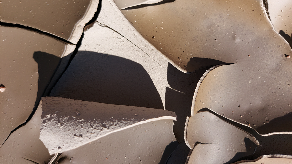 Cracked dry clay in close-up.