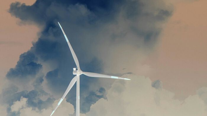 Wind turbine against cloudy sky