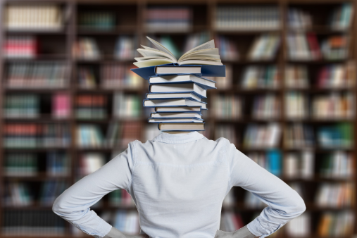 Person with white shirt, but her head is a stable of books. 