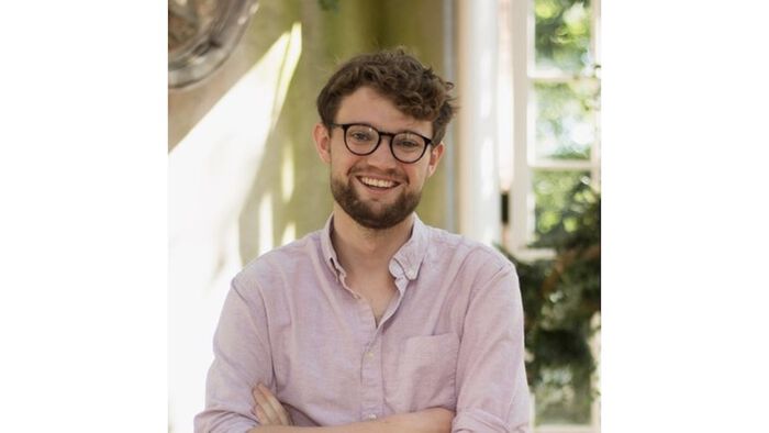 Portrait of Matthew Kinloch: a man with glasses, brown hair and a beard