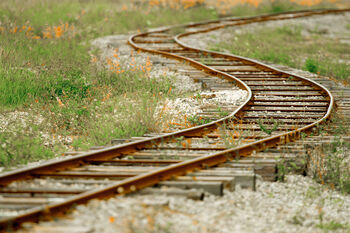 Abandoned rusty railway tracks in rural area