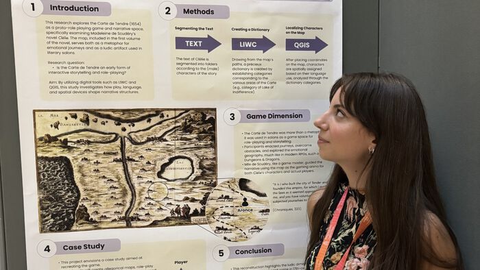 Photo of Saggioro standing in front of her poster. 