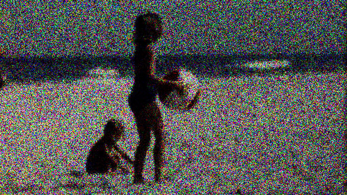 Two children on the beach. The picture is blury.